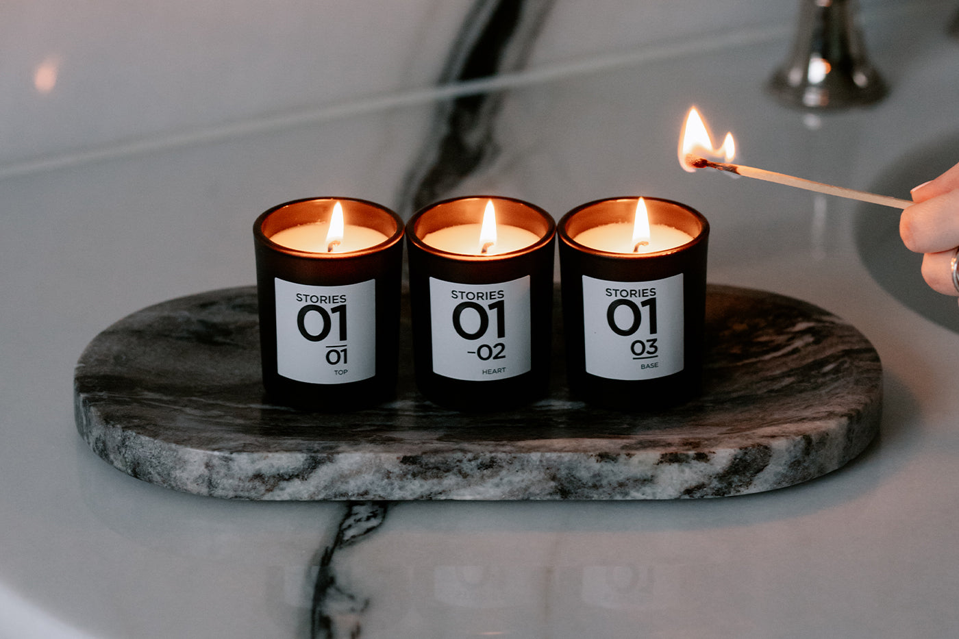 STORIES Parfums candles being lit in a bathroom