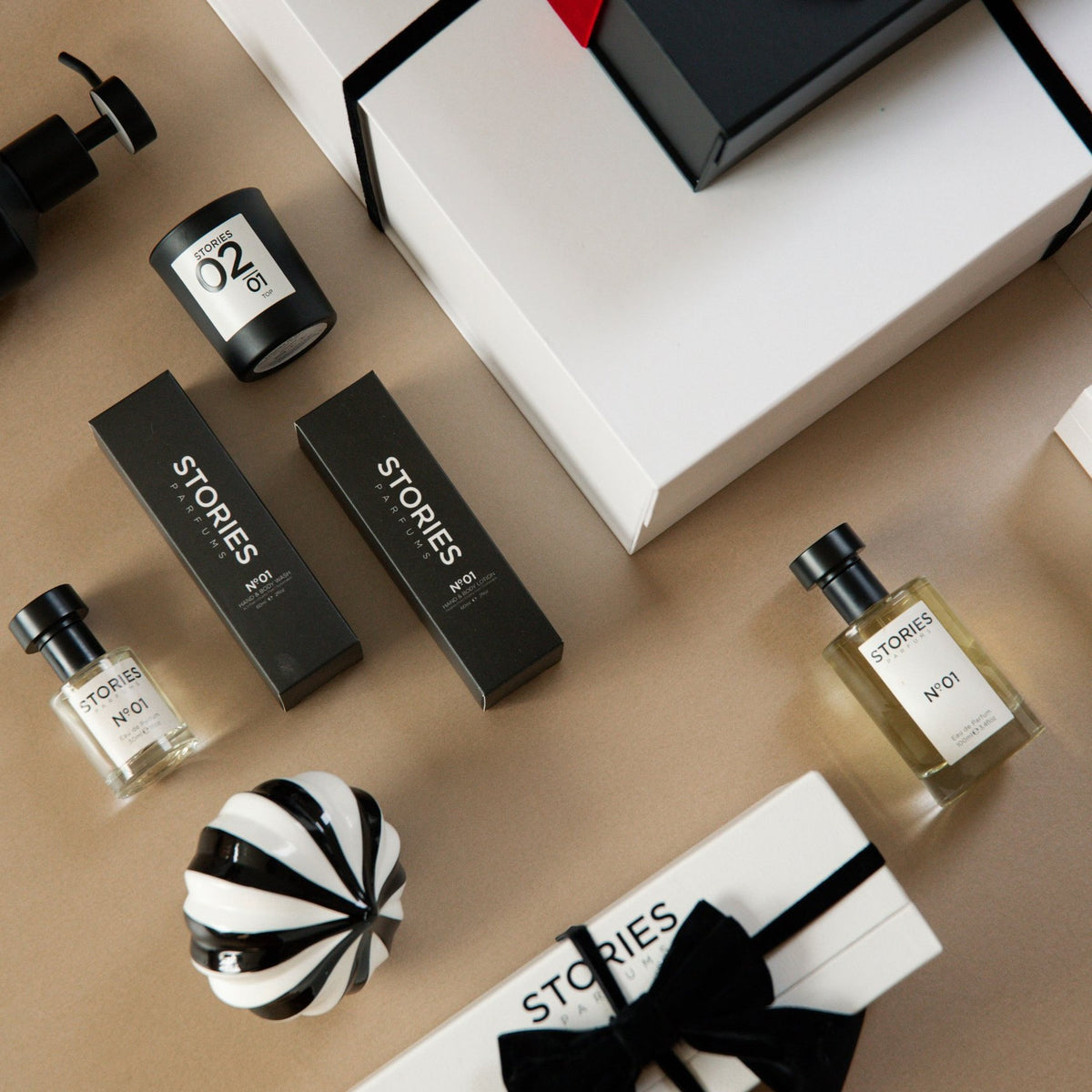 STORIES Nº.01 Christmas flat lay: Eau de Parfum in 100ml and 30ml, Hand & Body Wash and Lotion, and a Christmas Gift Box