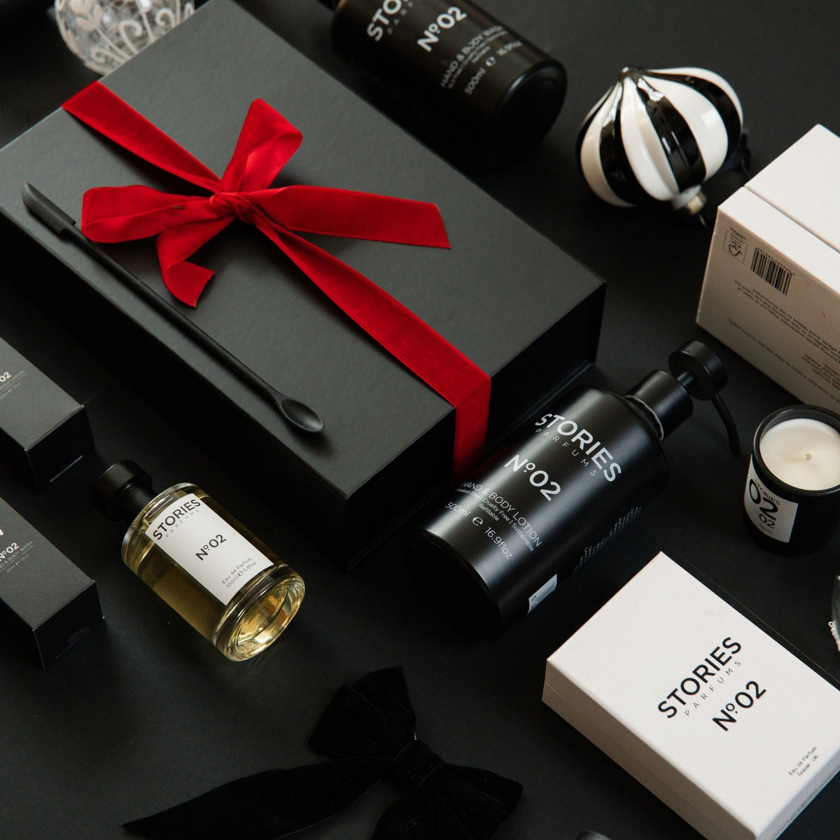 STORIES Nº.02 Christmas flat lay: 100ml Eau de Parfum, Hand & Body Wash and Lotion 500ml, and a Christmas Gift Box