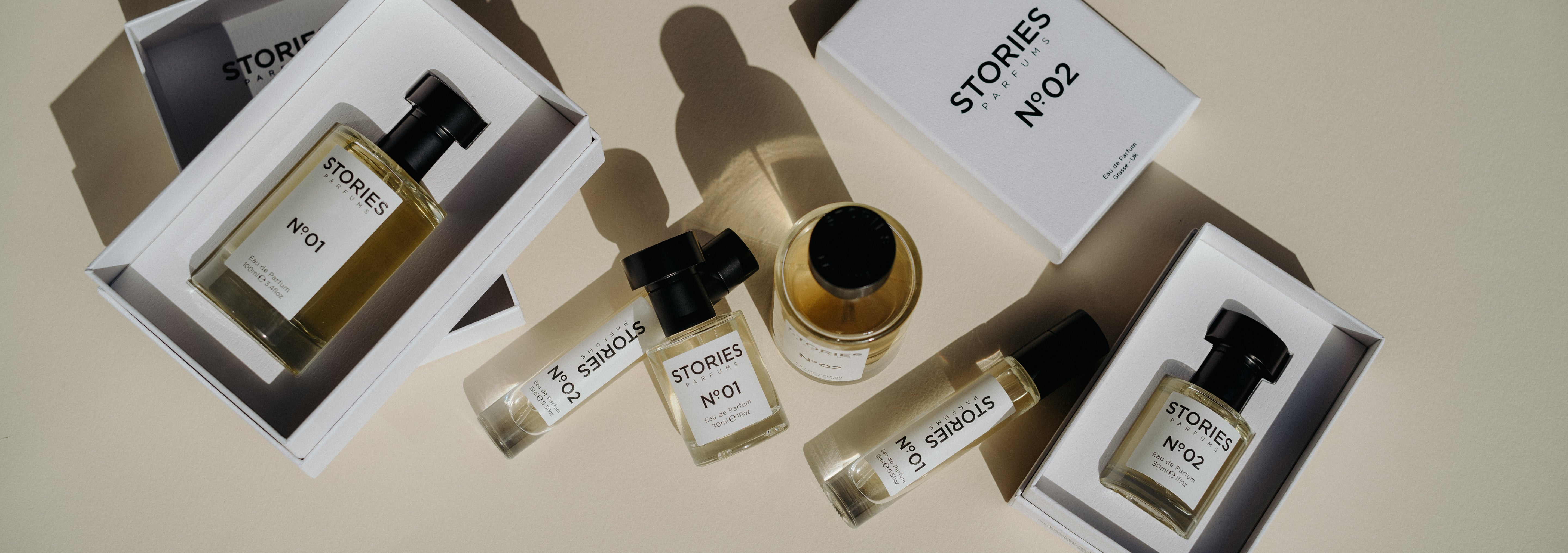 STORIES Parfums bottles and boxes artistically displayed laying on their sides