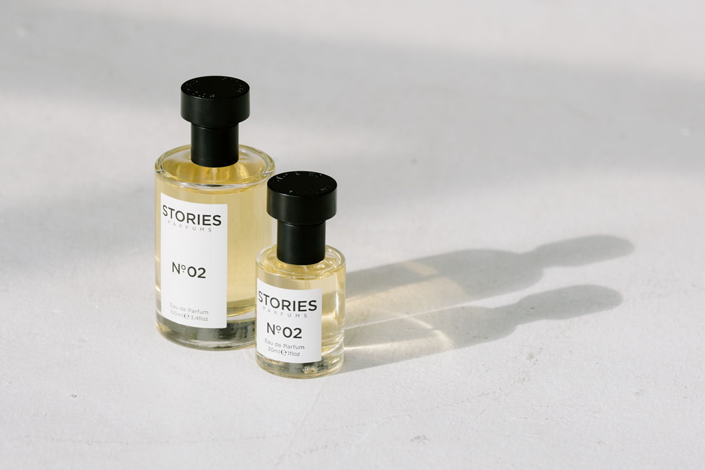 Two STORES Parfums bottles side by side