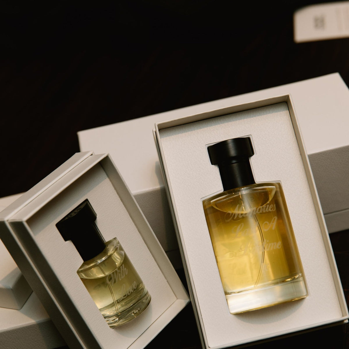STORIES Eau de Parfum bottles at 100ml and 30ml, each engraved with a personal message on the glass