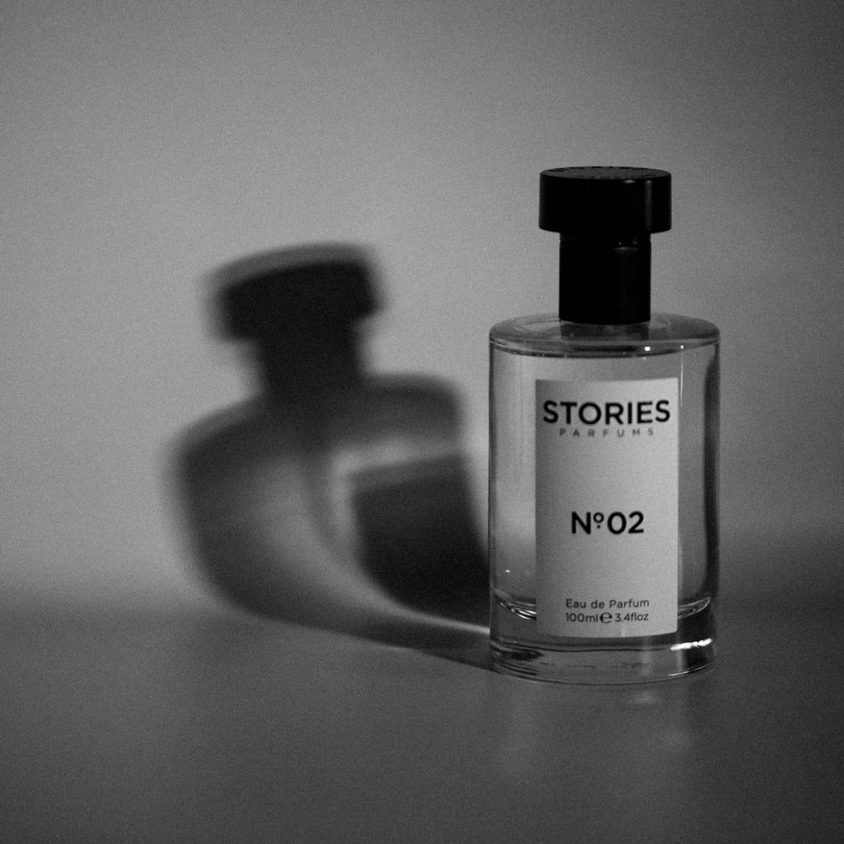 A bottle of STORIES Nº.02 Eau de Parfum casting its shadow